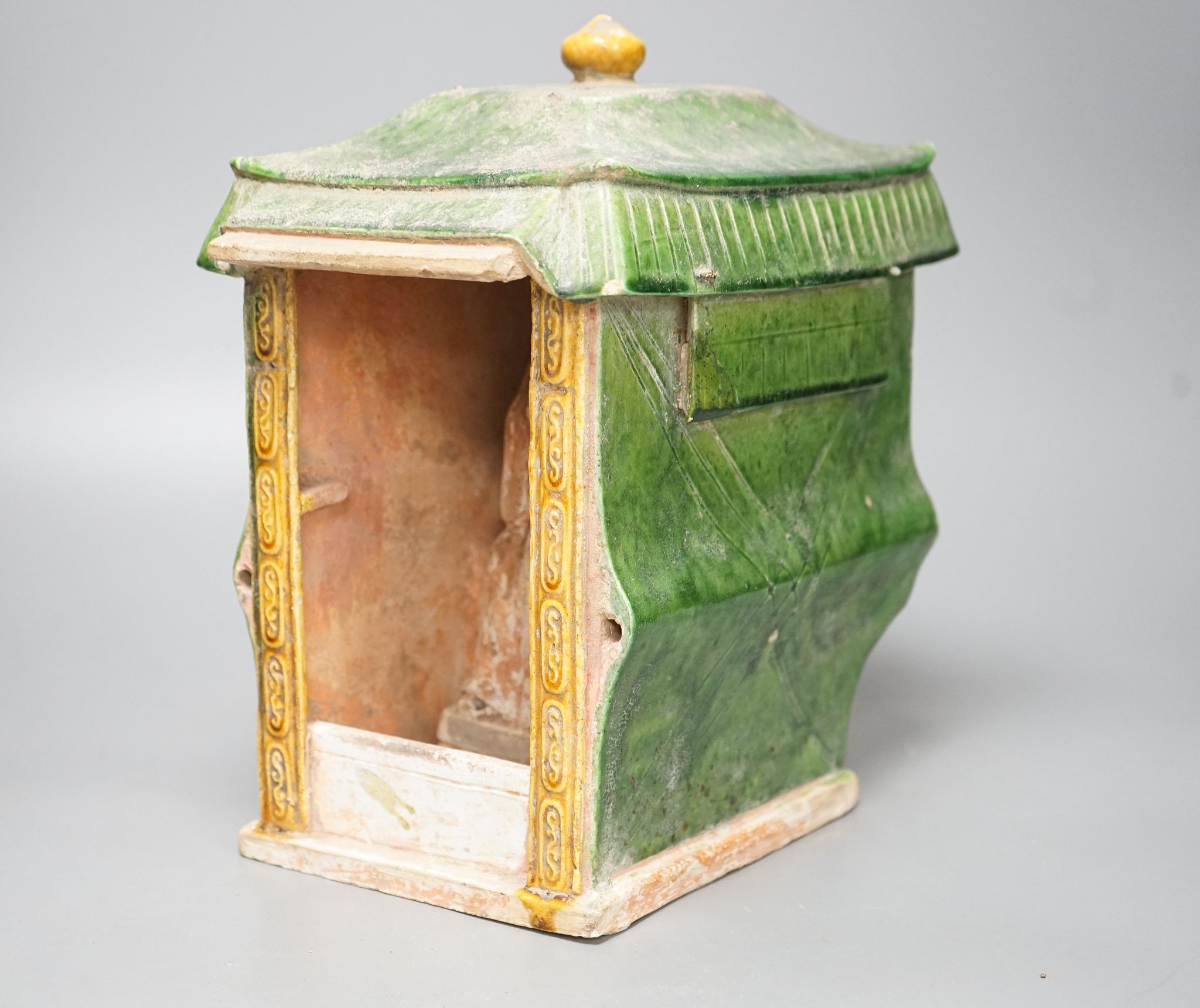 A Chinese Ming sancai-glazed model of a sedan chair with the figure Wenmu seated inside, 29cm